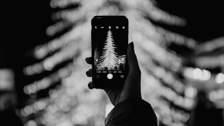 Lady Taking Photos of Christmas Tree