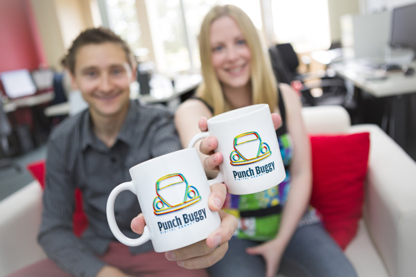 Punch Buggy mugs and the web development office in the background